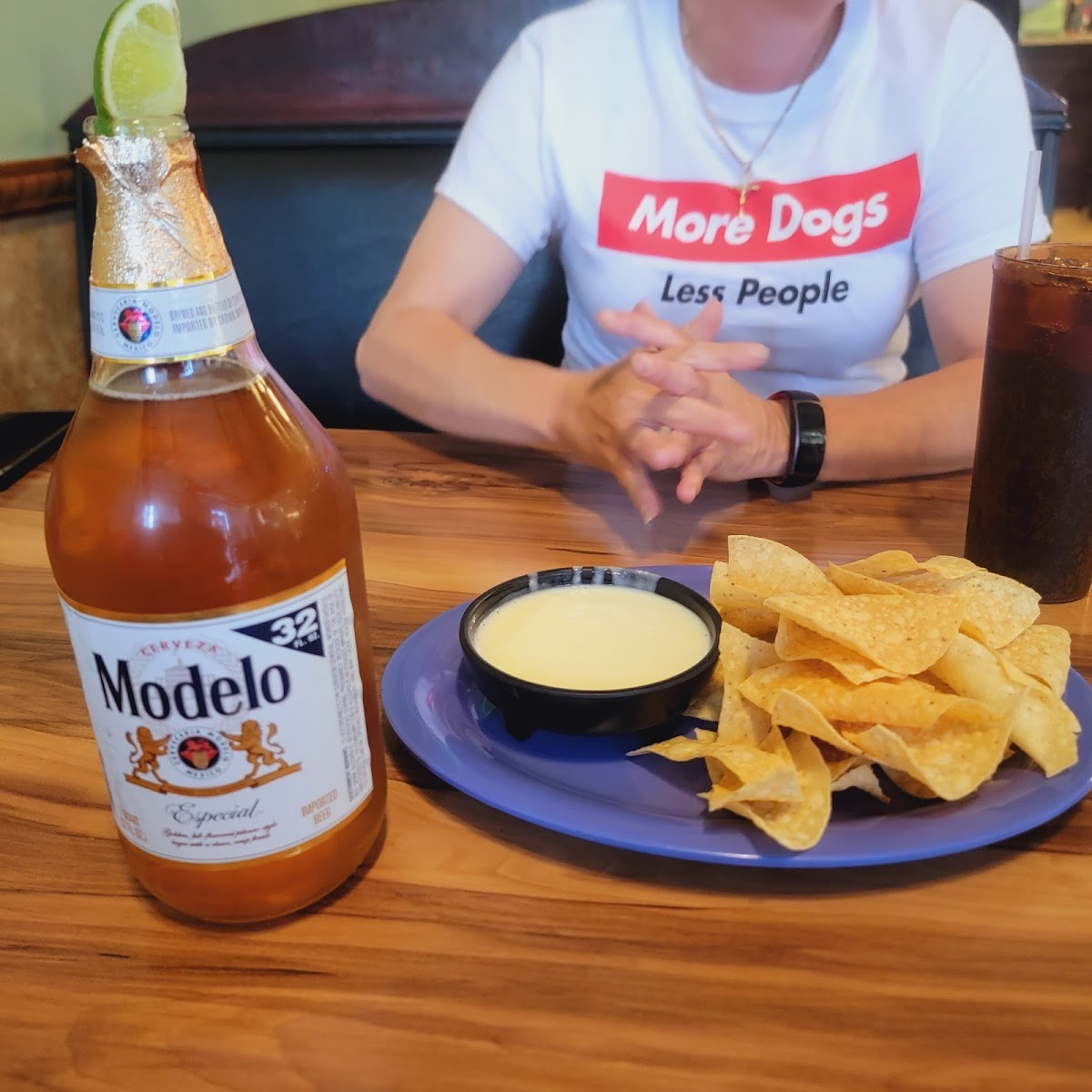 Ice-cold Modelo with chips and white queso from the full bar